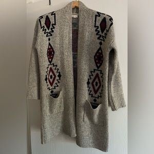 Long cardigan with pockets and geometric design, size small.
